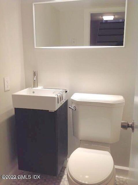 51 Northfield Street, Unit B Greenwich, CT 06830 - Photo 8 of 13 a bathroom with a sink a toilet and mirror