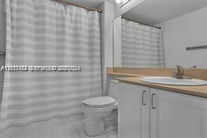 90 Alton Road, Unit 2303 Miami Beach, FL 33139 - Photo 23 of 29 a bathroom with a sink a toilet and shower