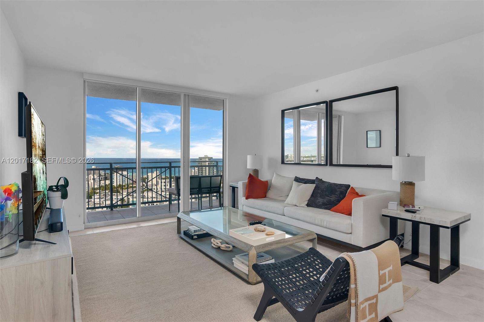 90 Alton Road, Unit 2303 Miami Beach, FL 33139 - Photo 4 of 29 a living room with furniture and a window