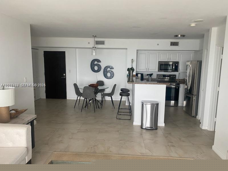 90 Alton Road, Unit 2303 Miami Beach, FL 33139 - Photo 6 of 29 a view of kitchen with refrigerator stove and microwave