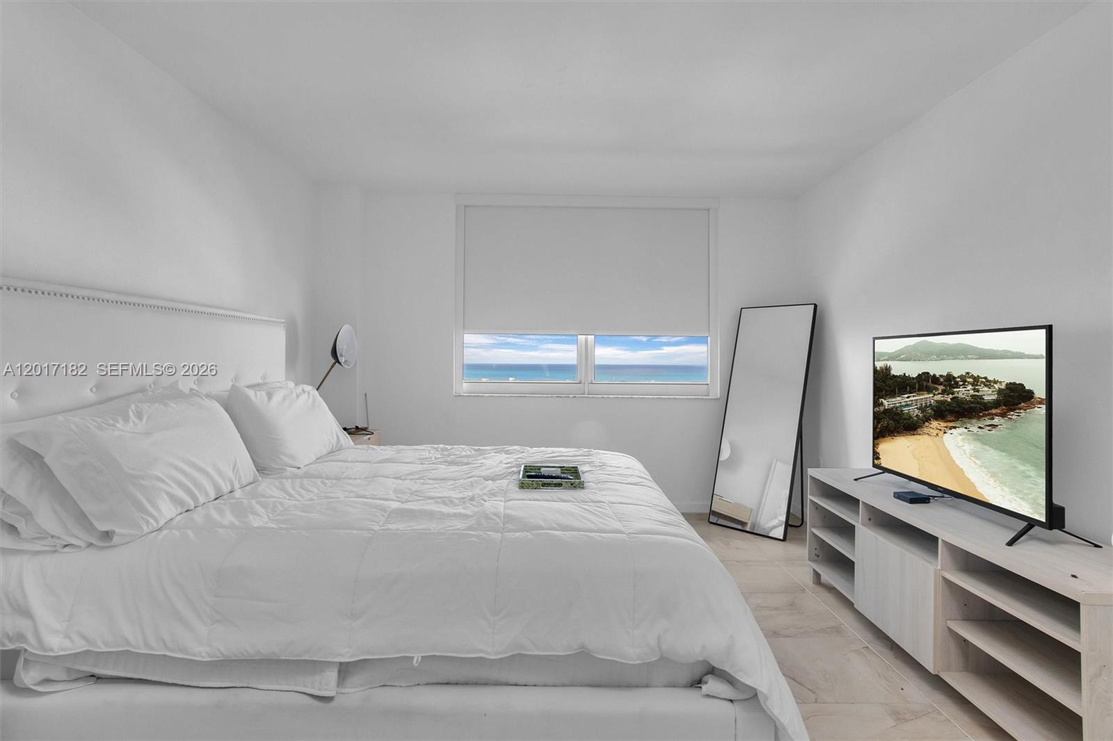 90 Alton Road, Unit 2303 Miami Beach, FL 33139 - Photo 8 of 29 a bedroom with a bed and window