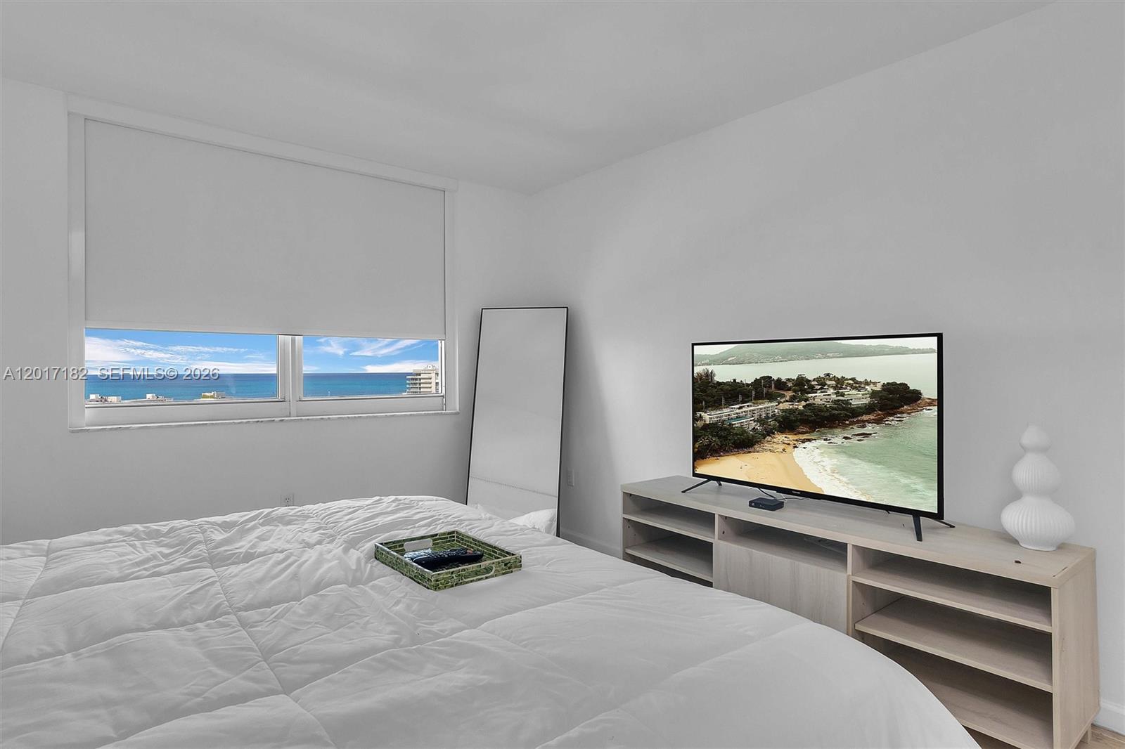 90 Alton Road, Unit 2303 Miami Beach, FL 33139 - Photo 9 of 29 a bedroom with bed and window