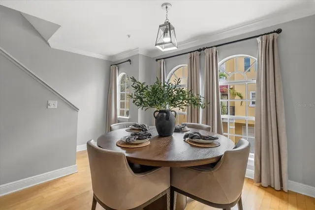 a view of a dining room with furniture window and wooden floor