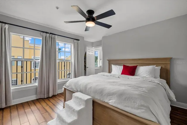 a bedroom with a large bed and a large window