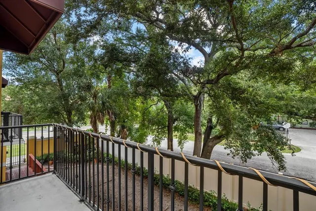 a view of a balcony with wooden fence and floor