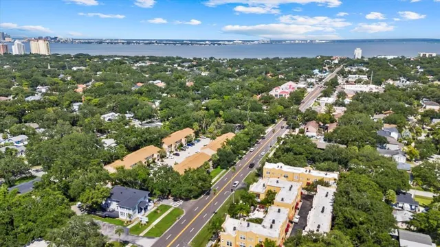 an aerial view of a house with yard and seating area
