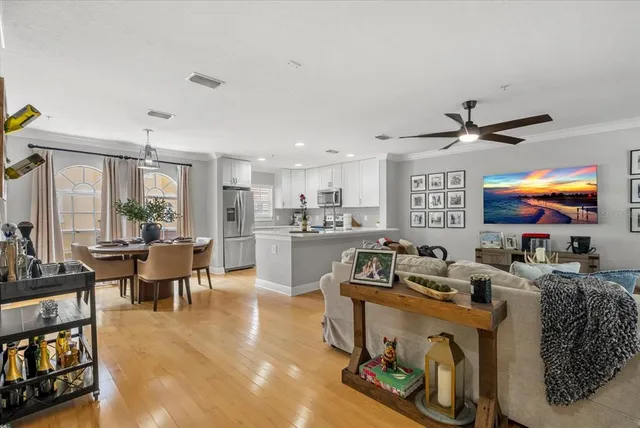 a living room with furniture a flat screen tv and a table