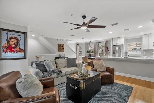 a living room with furniture and a ceiling fan
