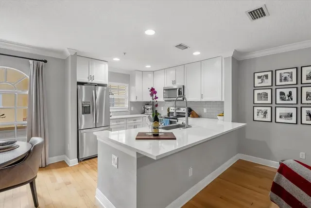 a kitchen with refrigerator and window