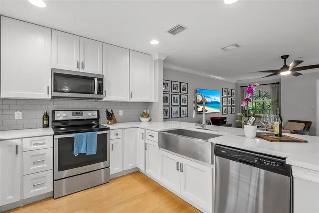 a kitchen with a sink stove and microwave