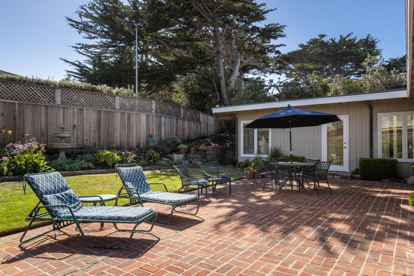 26177 Scenic Road Carmel, CA 93923 - Photo 12 of 30 a view of swimming pool with lawn chairs and plants