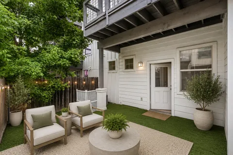 a view of a house with a wooden fence