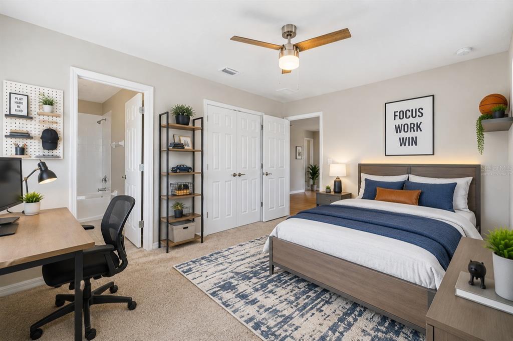 1192 Multiflora Loop Lutz, FL 33558 - Photo 26 of 32 a bedroom with a bed a desk and chair