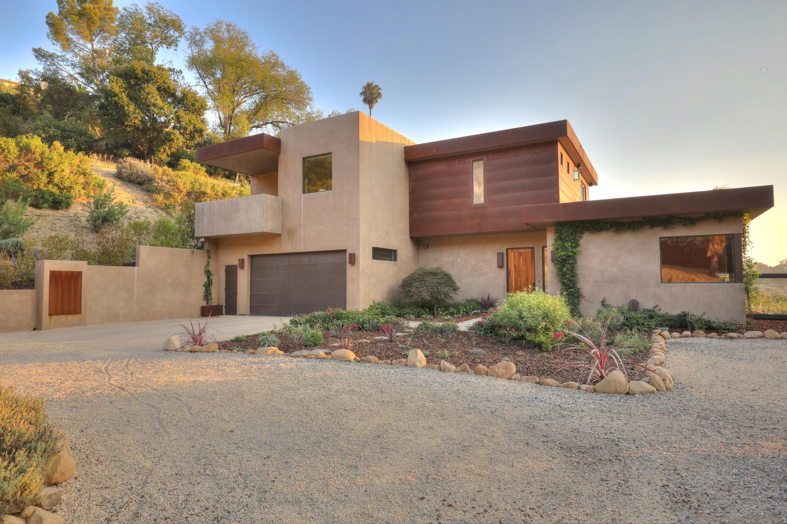 1100 Palomino Road Santa Barbara, CA 93105 - Photo 1 of 34 a front view of a house with a yard and garage