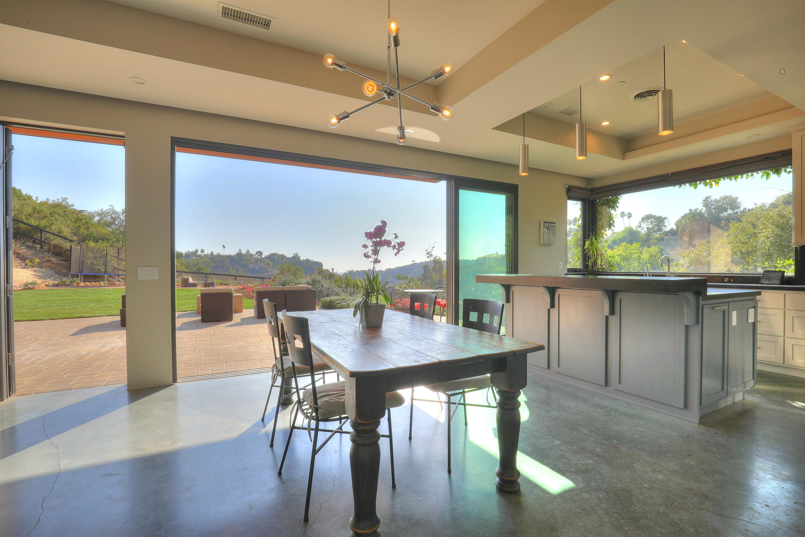 1100 Palomino Road Santa Barbara, CA 93105 - Photo 6 of 34 a view of a dining room with furniture large windows and wooden floor