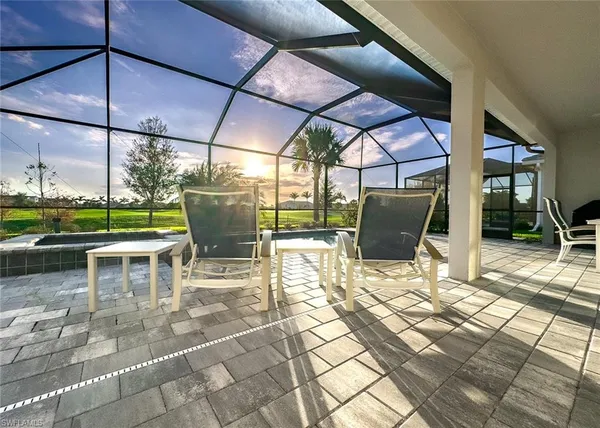 a view of a patio with a dining table and chairs