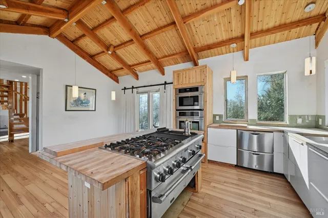 a kitchen with a stove and a wooden cabinets