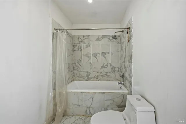 a bathroom with a shower and a toilet