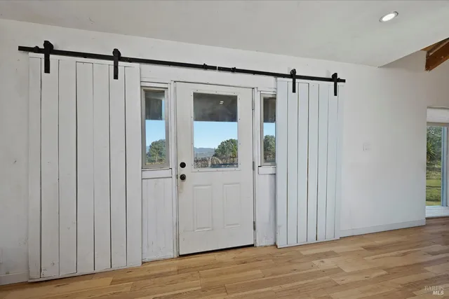 a view of a room with wooden floor and windows