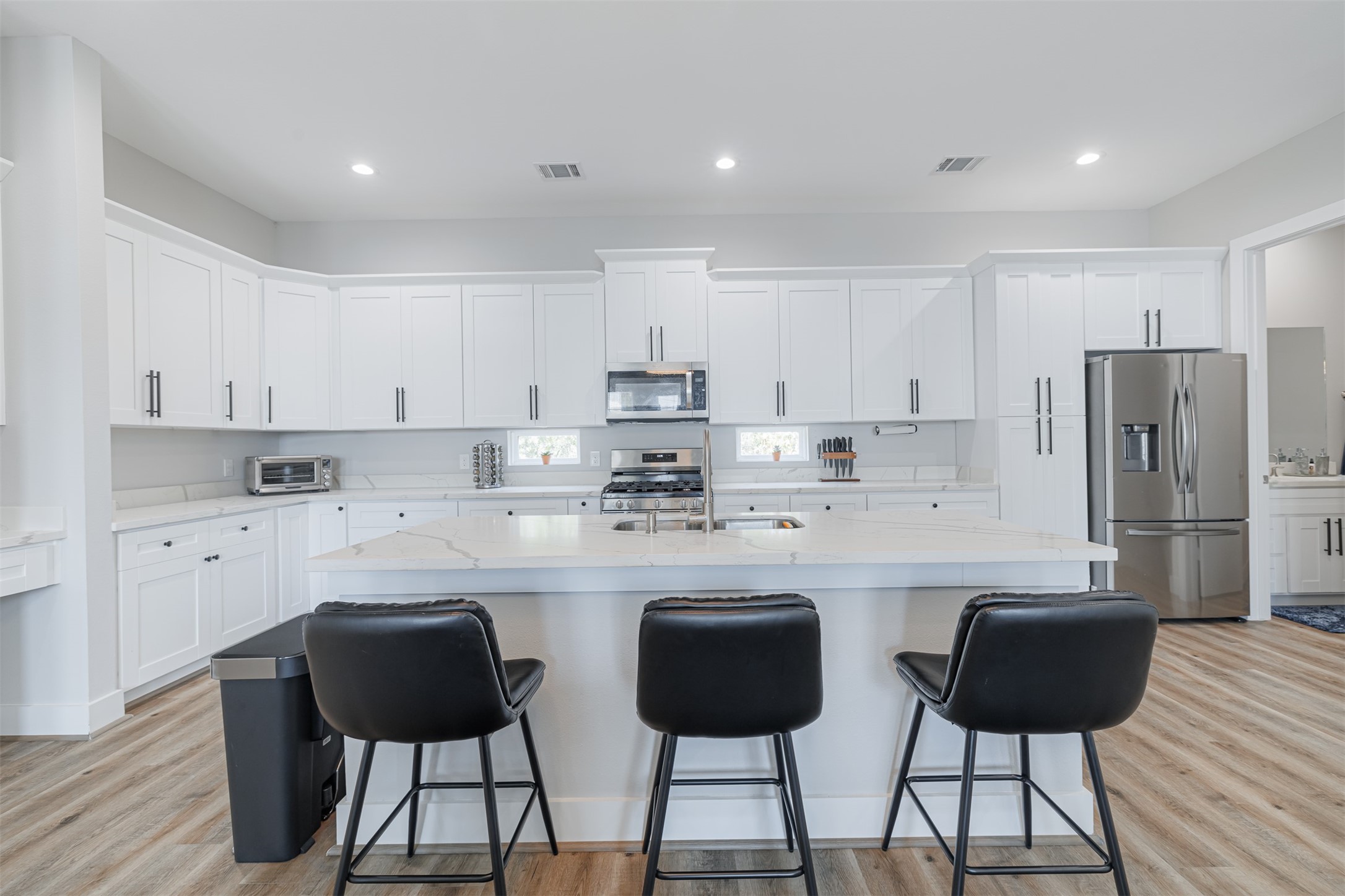 7814 De Priest Street Houston, TX 77088 - Photo 13 of 31 Kitchen also features a breakfast bar and recessed lighting.