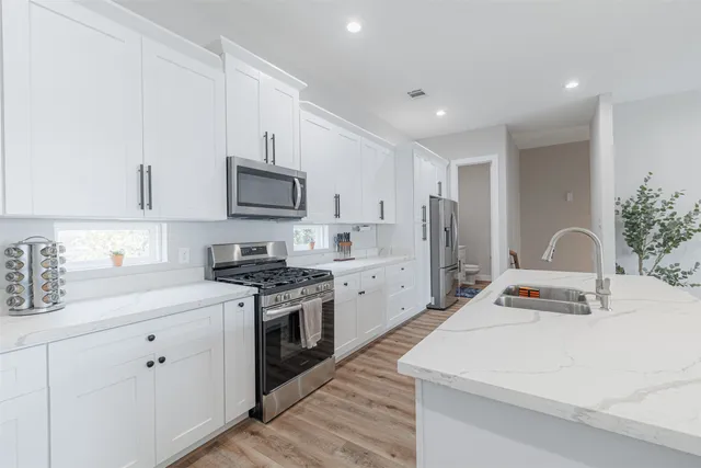 a kitchen with a stove a sink and a refrigerator