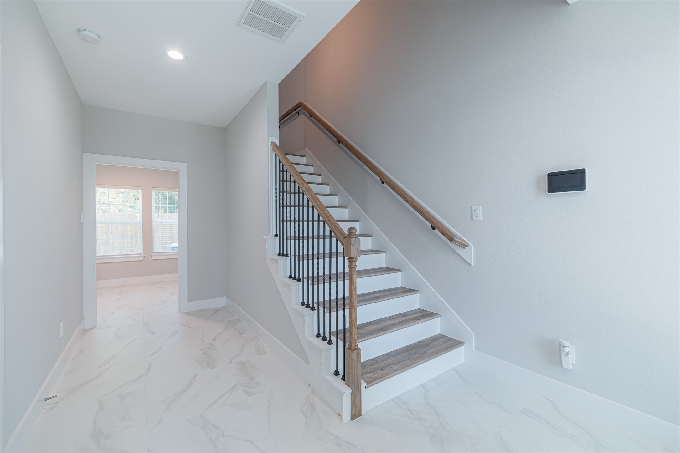 7814 De Priest Street Houston, TX 77088 - Photo 4 of 31 As you step through the front door, you're greeted by a welcoming hallway that leads to a private first-floor bedroom.