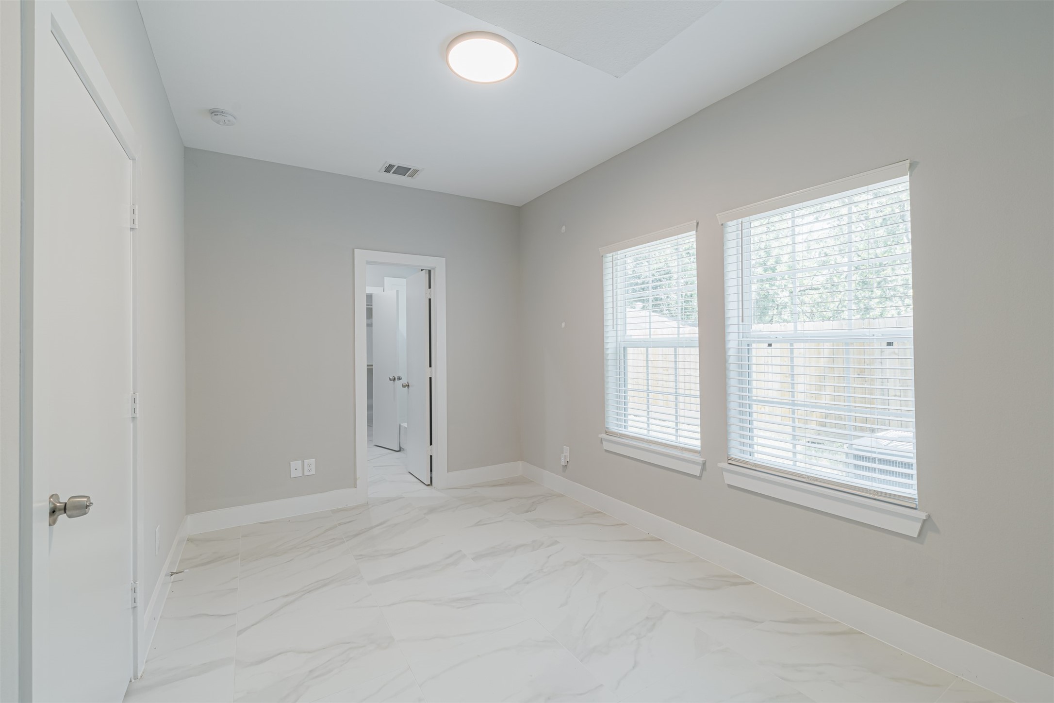 7814 De Priest Street Houston, TX 77088 - Photo 7 of 31 Private first-floor bedroom, complete with an ensuite bath and walk-in closet, ideal for guests or as a home office.