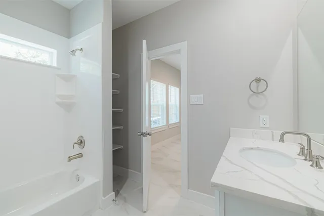 a bathroom with a sink and a bathtub