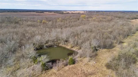 a view of a dry yard with wooden floor and fence