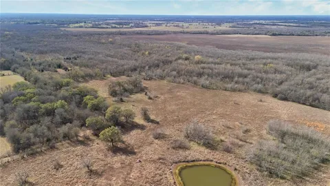 a bathroom with a granite countertop toilet and a sink