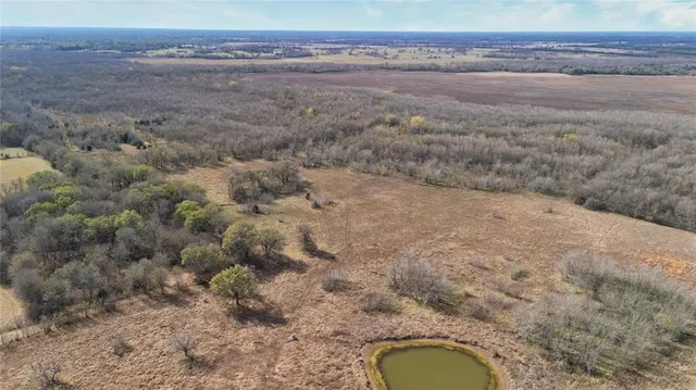 a bathroom with a granite countertop toilet and a sink