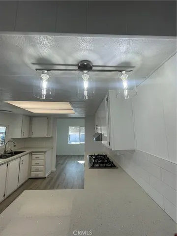 a open kitchen with a sink and cabinets