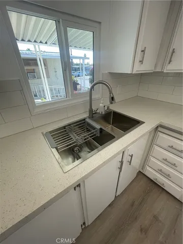 a white stove top oven sitting inside of a kitchen