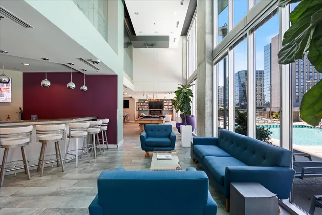 a living room with furniture and a large window