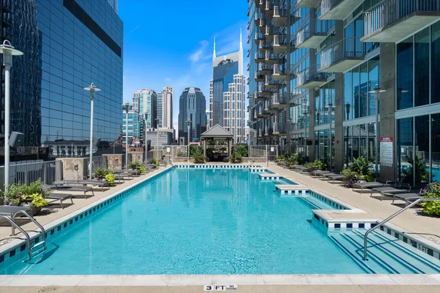 a swimming pool with outdoor seating and yard