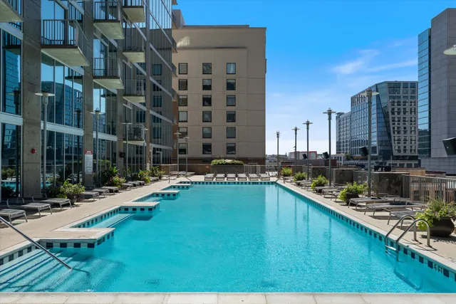 a swimming pool with outdoor seating and yard