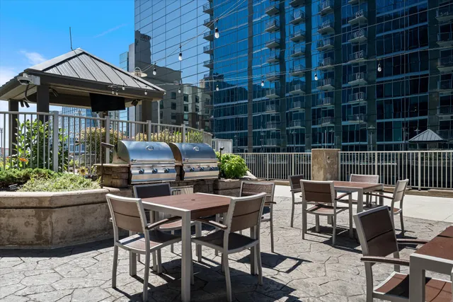 a view of a patio with table and chairs and potted plants