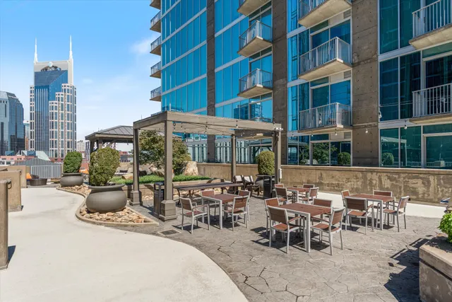 a view of a patio with couches table and chairs and potted plants