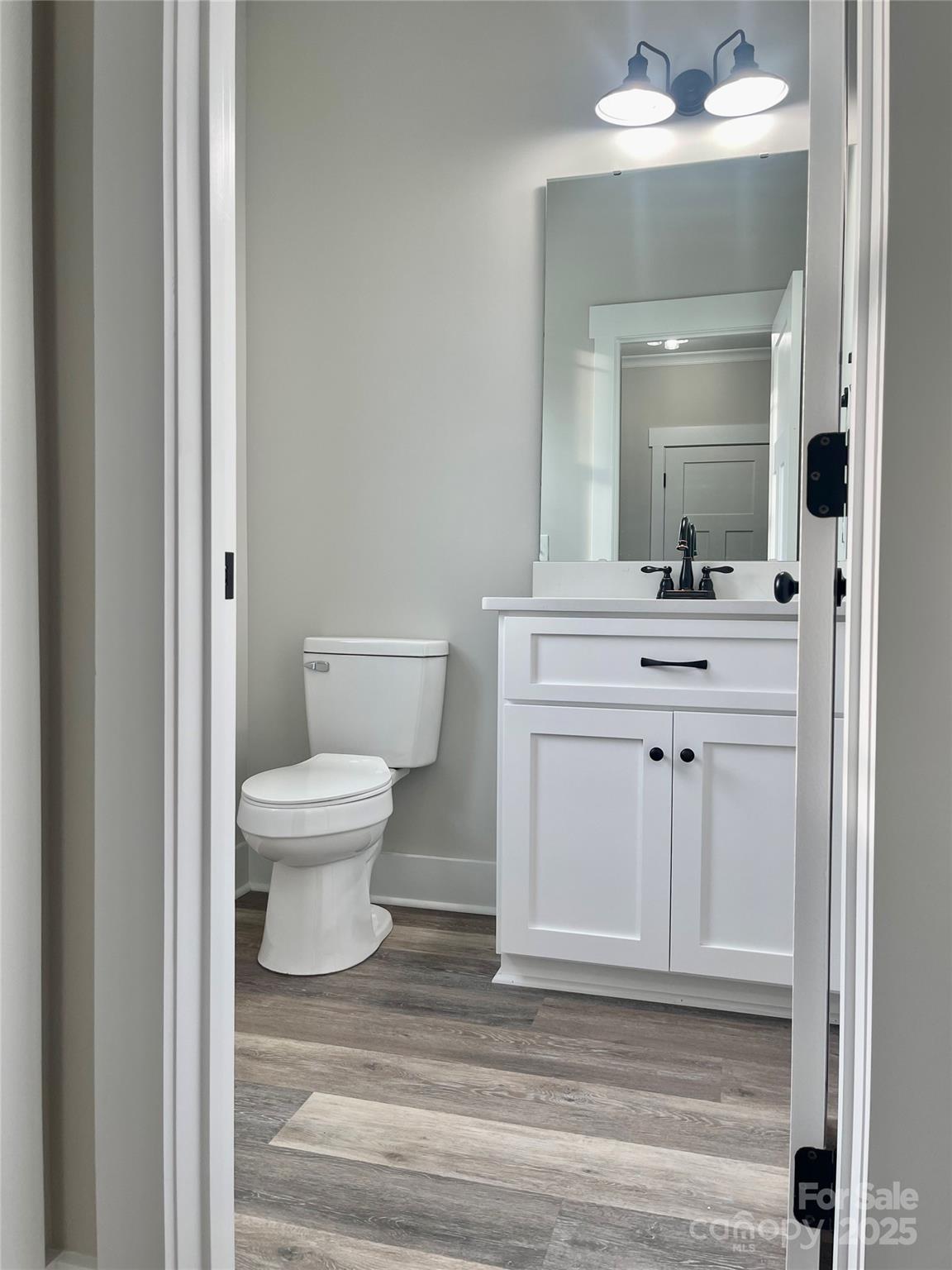 203 Prospect Church Road Albemarle, NC 28001 - Photo 12 of 44 a bathroom with a sink a toilet and mirror