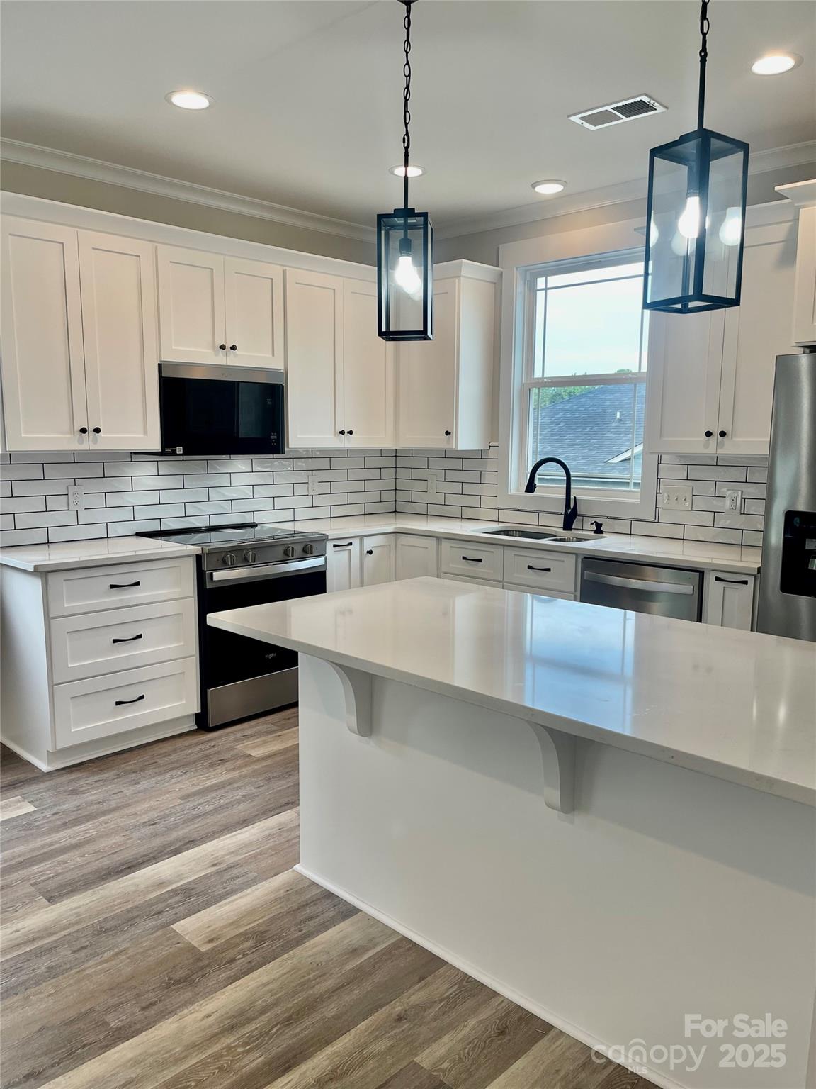 203 Prospect Church Road Albemarle, NC 28001 - Photo 6 of 44 a kitchen with stainless steel appliances granite countertop a sink a stove and a microwave oven