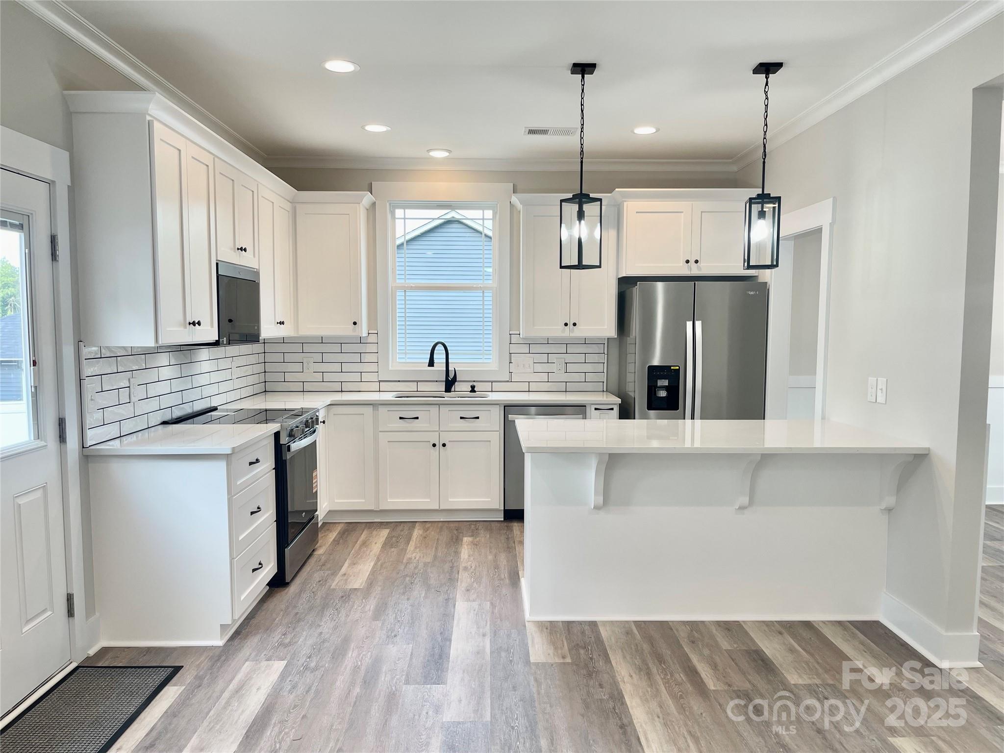 203 Prospect Church Road Albemarle, NC 28001 - Photo 7 of 44 a kitchen with stainless steel appliances sink refrigerator and microwave