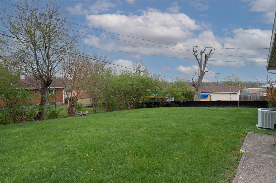 795 Spring Garden Place Dayton, OH 45431 - Photo 16 of 34 Expansive green space offers a serene backyard retreat perfect for outdoor enjoyment.