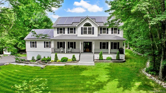 a front view of a house with a yard table and chairs