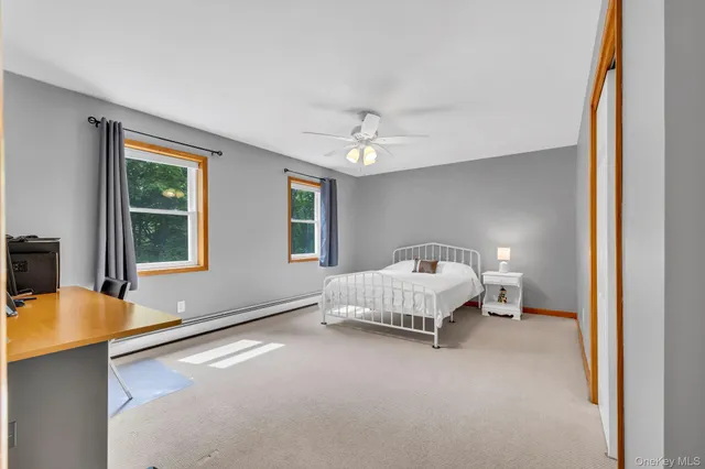 a bedroom with furniture and a window