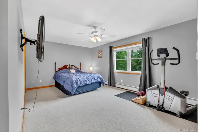 a spacious bedroom with a bed and a window