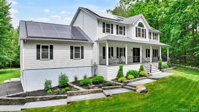 a front view of a house with garden and porch