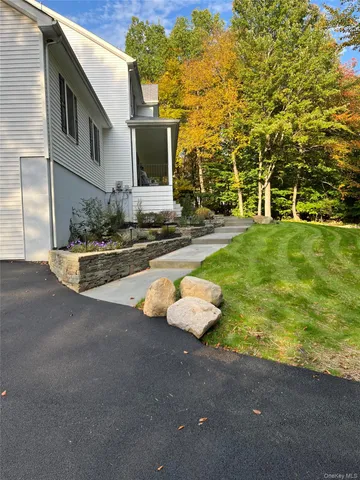 a aerial view of a house with backyard swimming pool and sitting area