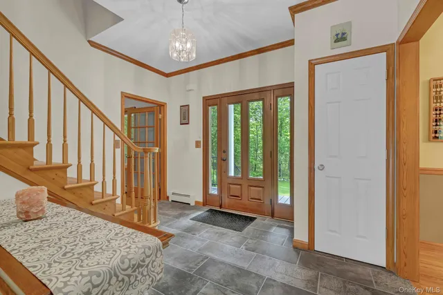 a view of a livingroom with wooden floor and stairs