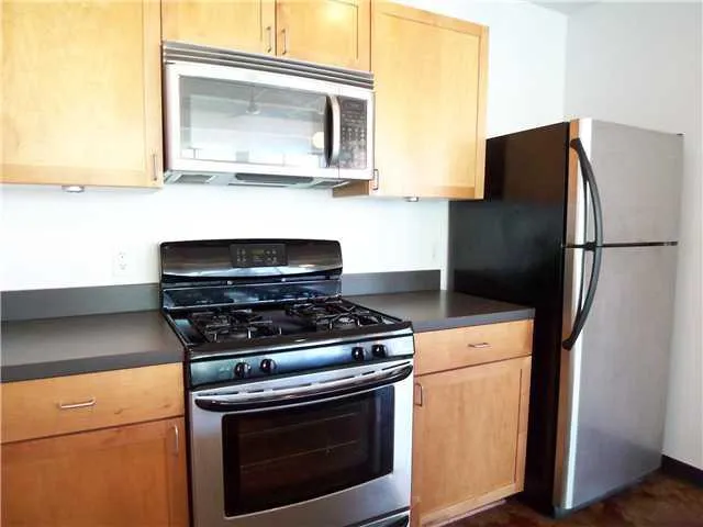a kitchen with a stove and a refrigerator