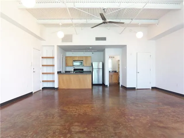 a view of a kitchen with a sink and a refrigerator